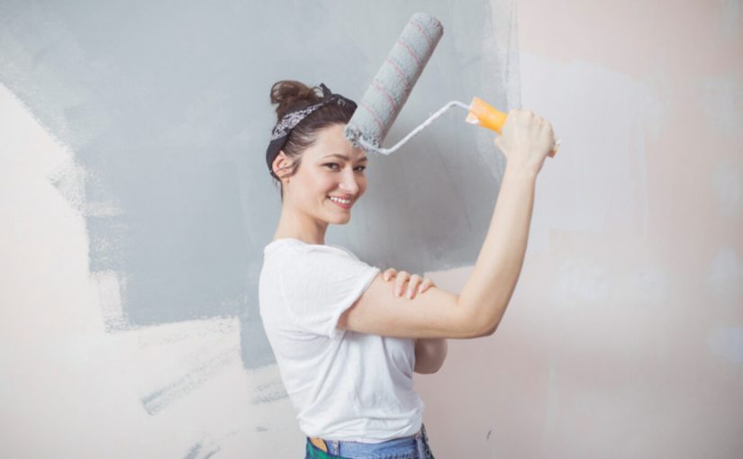 Young woman painting walls